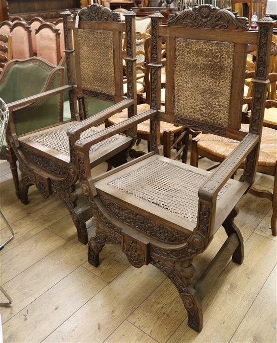 A pair of large French carved walnut elbow chairs